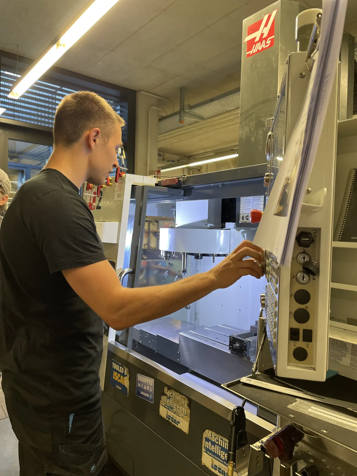 Elara engineer machining hardware on a CNC mill